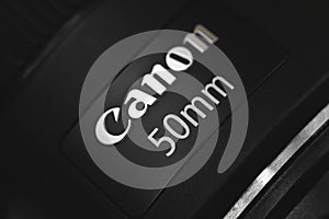 Kharkov, Ukraine - March 7, 2021: Canon 50mm most popular portrait lens, brand logo close up