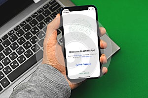 Kharkov, Ukraine - March 9, 2021: Man using Whatsapp application, title screen of app for messaging