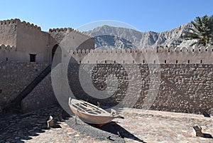 Khasab Castle Wall with Mountains and Boat