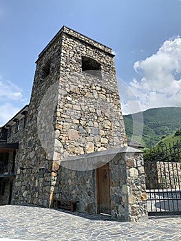 Khidikus. Ancestral tower of Gusov family, 17th century, was restored in 2010. Alan dormition monastery. Russia, North Ossetia, Fi