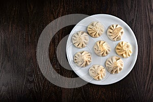 Khinkali on a white plate. Traditional Georgian dumplings. National dish of Georgian cuisine. Top view flat lay