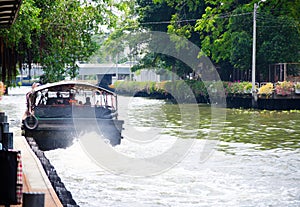 The Khlong Saen Saep boat service, the image shows a rear of public boat when starting the engine and leaving the pier.