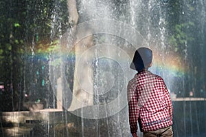 KHMELNITSKY, UKRAINE - JULY 29, 2017: Boy is standing by the fountain.