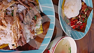 Khmer breakfast dishes, rice with pork or Bai Sach Chrouk and fried fish in spicy sauce or Trei boeng kanh chhet