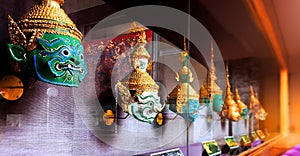 â€œKhonâ€ the Thais traditional masks in a glass display cabinet