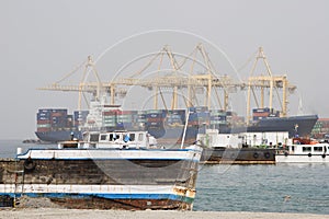 Khor Fakkan UAE old wooden dhow washed up on shore in front of Khor Fakkport