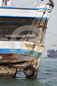 Khor Fakkan UAE old wooden dhow washed up on shore in front of Khor Fakkport