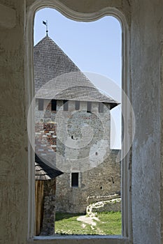 Khotyn fortress tower through an old window