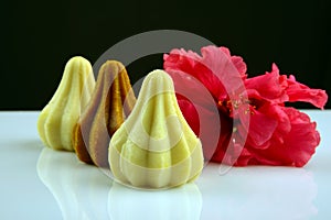 Khoya Modak with red hibiscus flower, an Indian traditional sweet