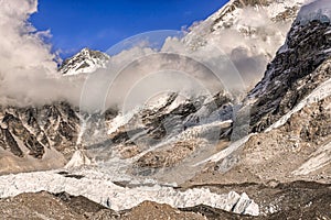 Khumbutse peak coming out of clouds over Khumbu Glacier in Nepal near Everest Base camp photo