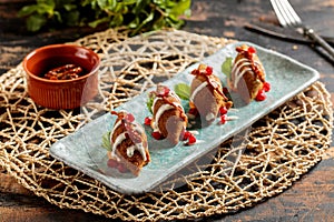 Kibbeh or kibe, quibe, kibbe with mayo dip, chilli sauce and pomegranate seeds served in dish isolated on table top view of arabic photo