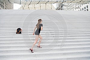 Kick feet up and go. Energetic woman climb stairs outdoors. Active life. Freedom from care. Free and carefree. Freedom