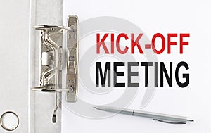 KICK-OFF MEETING text on the paper folder with pen. Business concept