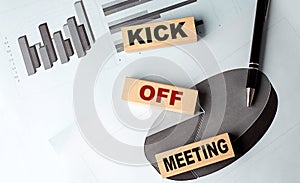 KICK OFF MEETING text on wooden block on chart background