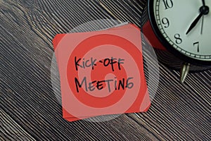Kick-off Meeting write on sticky notes isolated on Wooden Table