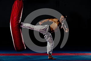 Kickbox fighter training in the gym with the punch bag