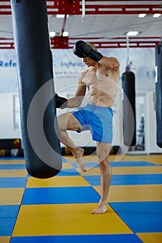 Kickbox fighter training with the punch bag