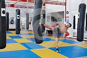 Kickbox fighter training with the punch bag