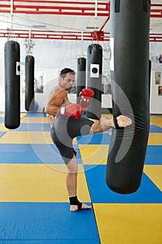 Kickbox fighter training with the punch bag