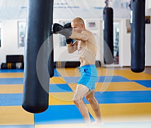 Kickbox fighter training with the punch bag