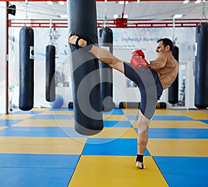Kickbox fighter training with the punch bag