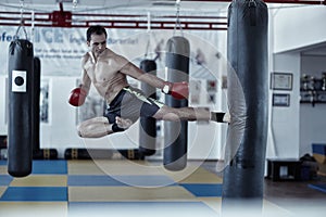 Kickbox fighter training with the punch bag