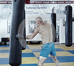 Kickbox fighter training with the punch bag