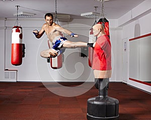Kickbox fighter working with the dummy