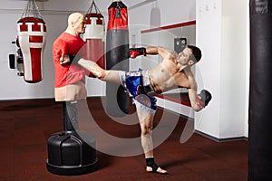 Kickbox fighter working with the dummy