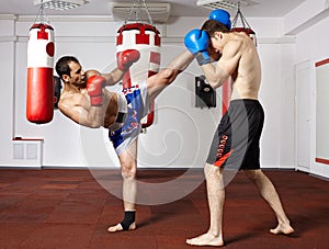 Kickbox fighters sparring in the gym
