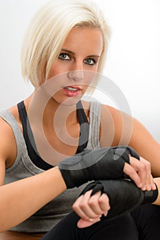 Kickbox woman put on protective gloves fitness