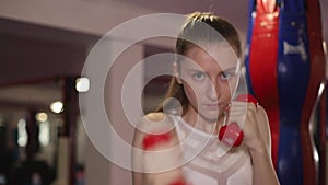 Kickboxer girl in the gym. Sports girl. Kickboxing concept. Women`s martial arts