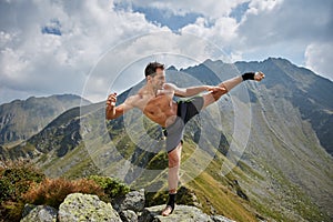 Kickboxer or muay thai fighter training on a mountain