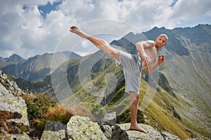 Kickboxer or muay thai fighter training on a mountain