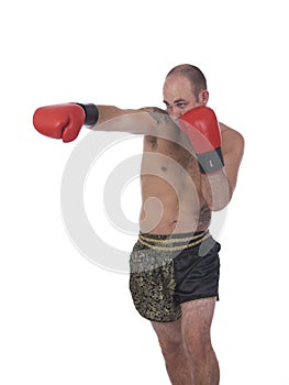 Kickboxer punching with red gloves from the side