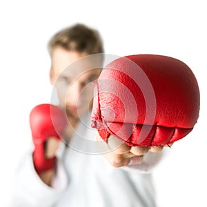 Kickboxer with red boxing gloves performing a martial arts punch