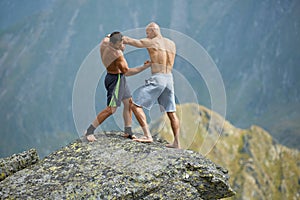 Kickboxers or muay thai fighters training on a mountain cliff