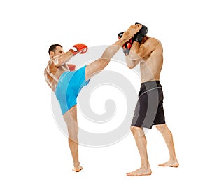 Kickboxers sparring on white