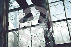 a kickflip captured midair with broken windows background