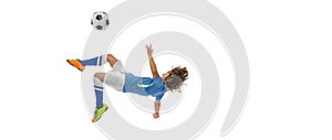 Flyer. Little boy, football soccer player in action, motion training isolated on white studio background. Concept of