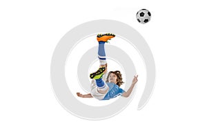 Little boy, football soccer player in action, motion training isolated on white studio background. Concept of sport