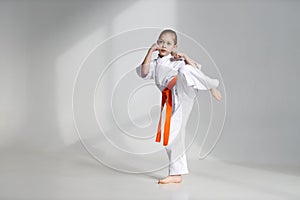Kicking stand, karate child on a white background
