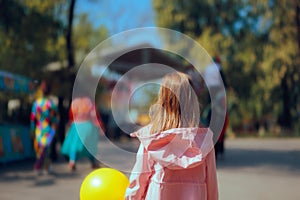 Child Looking at Circus Performers in an Amusement Park photo