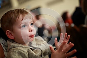 Kid applauding in theater