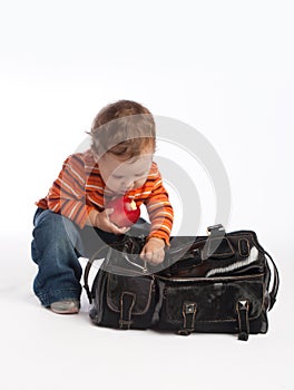 Kid with apple unzips female bag