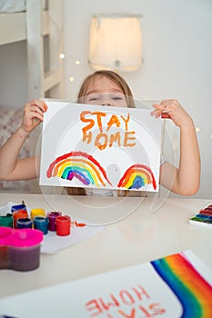 Kid drew rainbow and poster stay home. photo