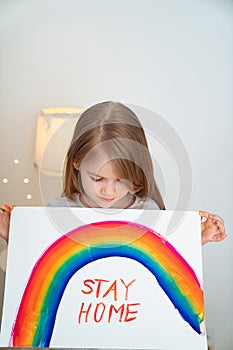 Kid drew rainbow and poster stay home. photo