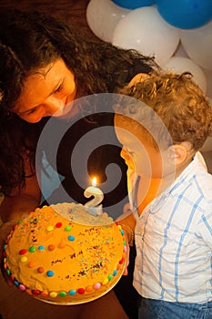 Un bambino soffiando candele sul torta di compleanno 
