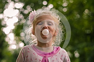 Kid blowing chewing gum bubbles