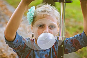 Kid blowing chewing gum bubbles